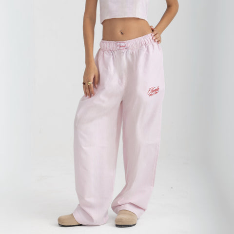 Unisex wide-leg striped cotton pants in pink and white, relaxed slouchy fit, modeled with casual summer outfit.