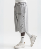 Unisex grey long shorts made of 100% cotton with raw hem edges and chunky waistband.