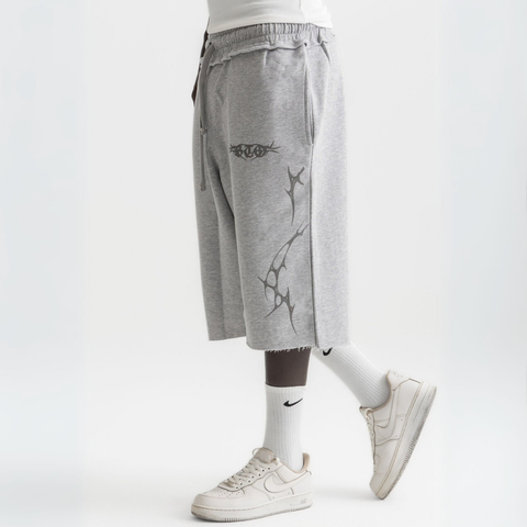 Unisex grey long shorts made of 100% cotton with raw hem edges and chunky waistband.