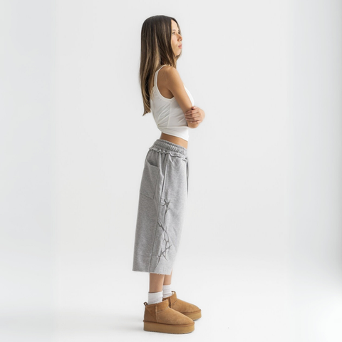 Unisex grey long shorts made of 100% cotton with raw hem edges and chunky waistband.