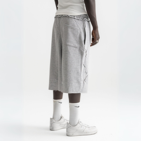 Unisex grey long shorts made of 100% cotton with raw hem edges and chunky waistband.