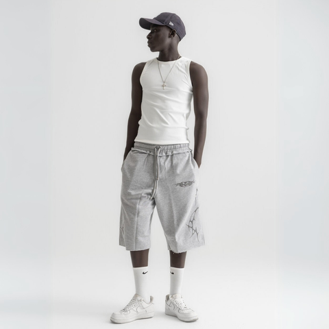 Unisex grey long shorts made of 100% cotton with raw hem edges and chunky waistband.