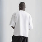 Men’s white box-fit oversized tee, front view showcasing relaxed fit and minimalist design.