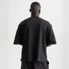 Men’s black box-fit oversized tee, front view showcasing relaxed fit and minimalist design.