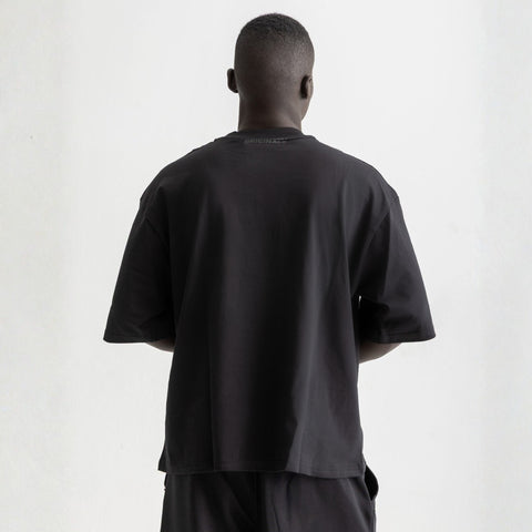 Men’s black box-fit oversized tee, front view showcasing relaxed fit and minimalist design.