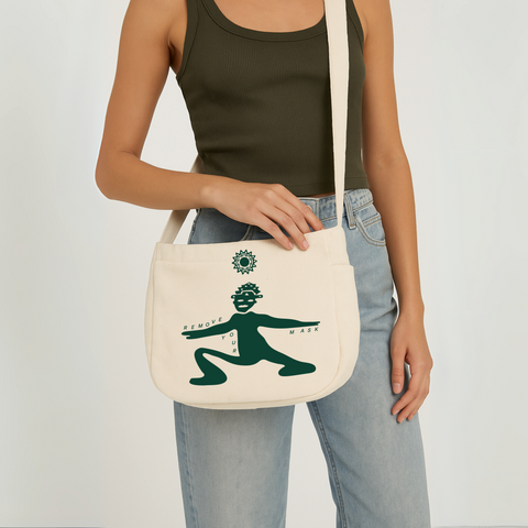 Limited edition canvas crossbody bag in beige featuring side pocket, inner compartments, and front and back design in dark green.