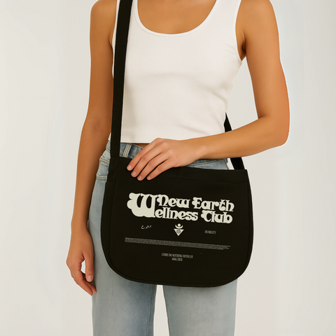 Limited edition canvas crossbody bag in black featuring side pocket, inner compartments, and front and back design in black.