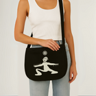 Limited edition canvas crossbody bag in black featuring side pocket, inner compartments, and front and back design in black.