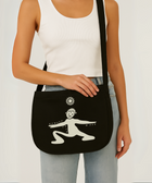 Limited edition canvas crossbody bag in black featuring side pocket, inner compartments, and front and back design in black.