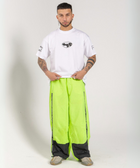 Unisex wide-fit waterproof pants in soft polyester with side stripe logo and adjustable waistband.