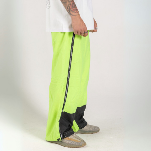 Unisex wide-fit waterproof pants in soft polyester with side stripe logo and adjustable waistband.
