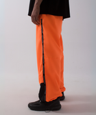 Unisex wide-fit waterproof pants in soft polyester with side stripe logo and adjustable waistband.