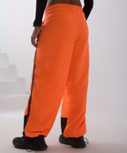 Unisex wide-fit waterproof pants in soft polyester with side stripe logo and adjustable waistband.