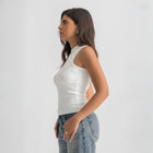 white ribbed basic tank top for women, side view showcasing fitted silhouette and minimal design.
